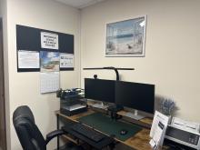 Inside of a Legal Self-Help Center showing a double monitor, comfortable chair, and printer